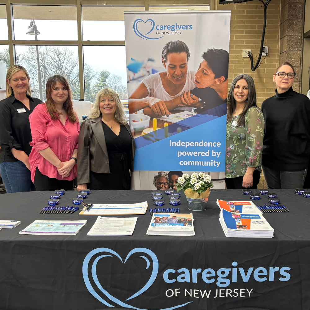 Caregivers of New Jersey staff sharing transition and disability resources at a community event.