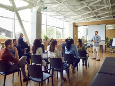 Young,Berded,Man,Speaking,On,A,Business,Training,Standing,In